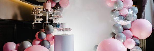 Delicious wedding reception. Birthday Cake on a background balloons party decor. Copy space. Celebration concept. Trendy Cake. Candy bar. Table with sweets, candies, dessert.